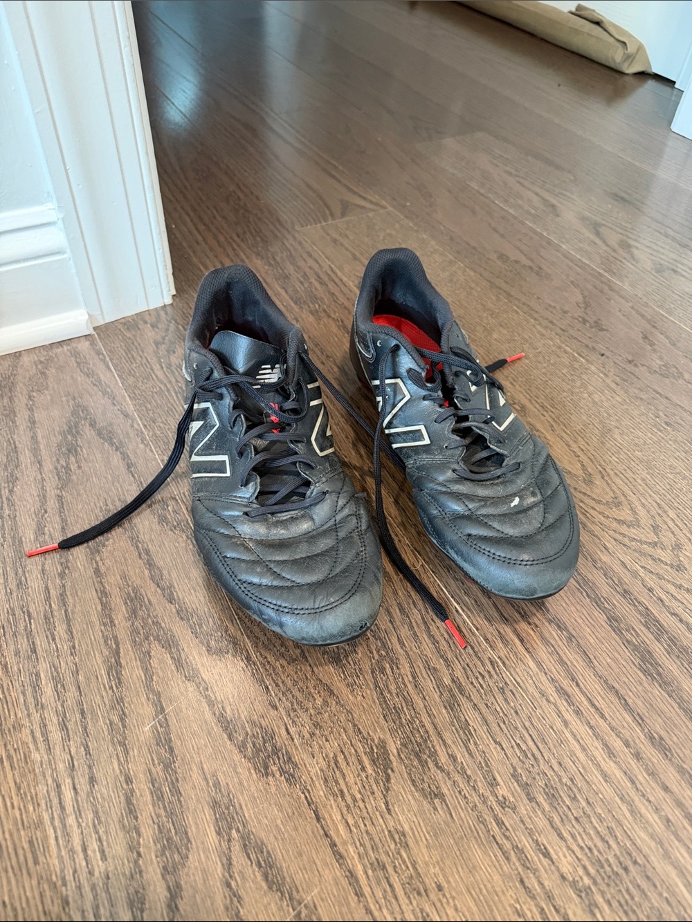 New Balance Men’s Black Athletic soccer cleats with Red Accents